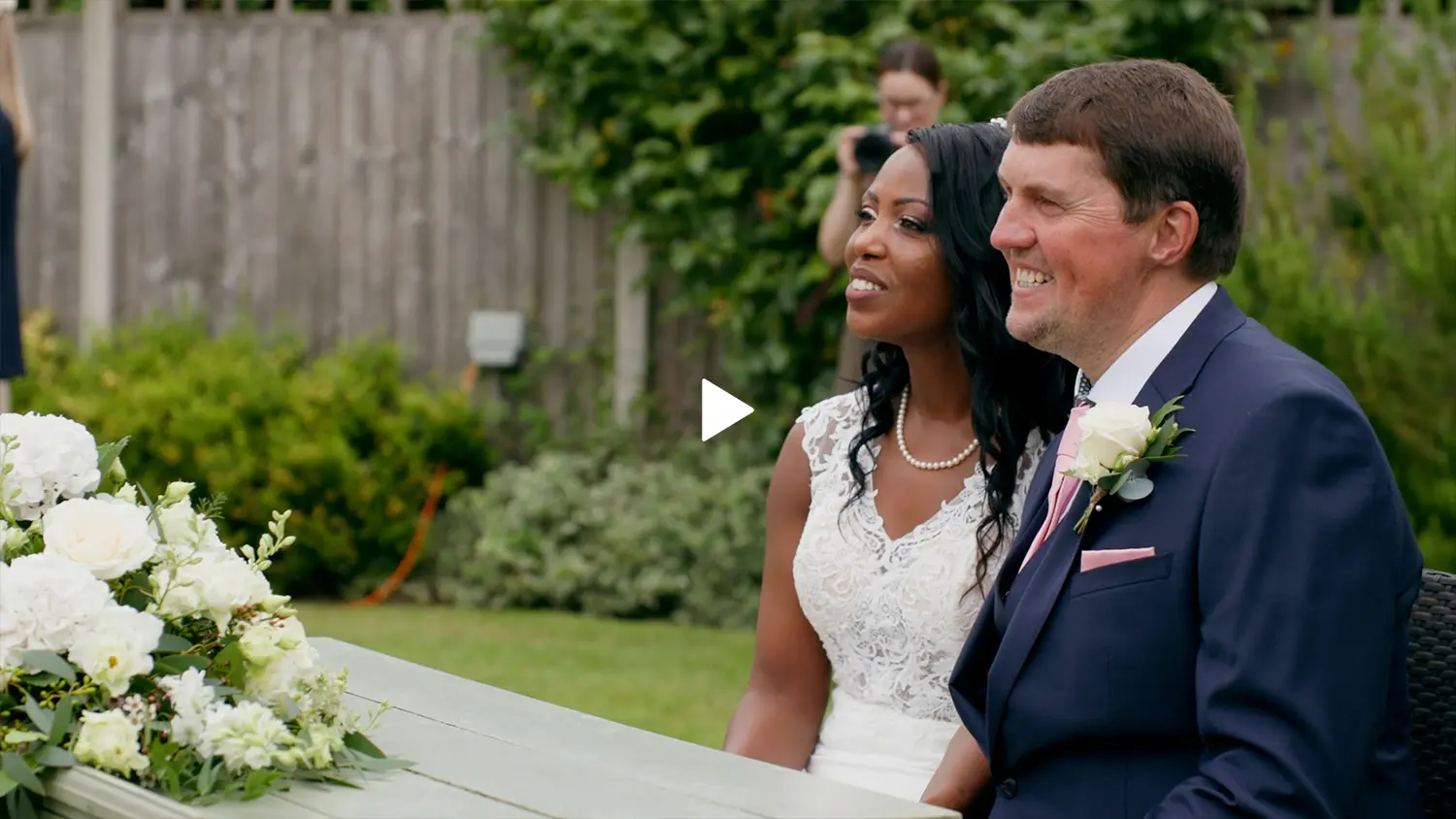 Frame of a couple, Nick and Pru posing for photographs on their wedding day.